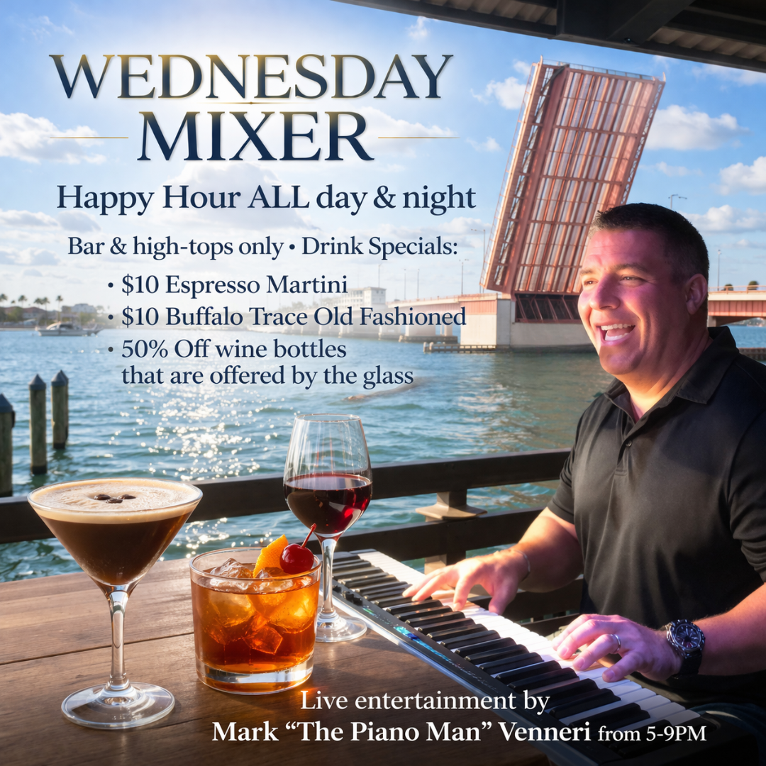 man playing piano with drinks in front of him and water and a draw bridge behind him